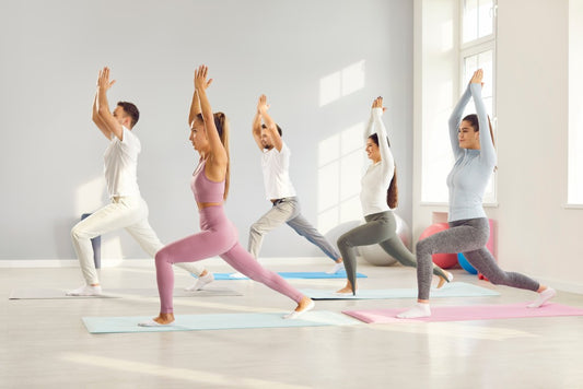 Group of employees doing yoga on their corporate retreat