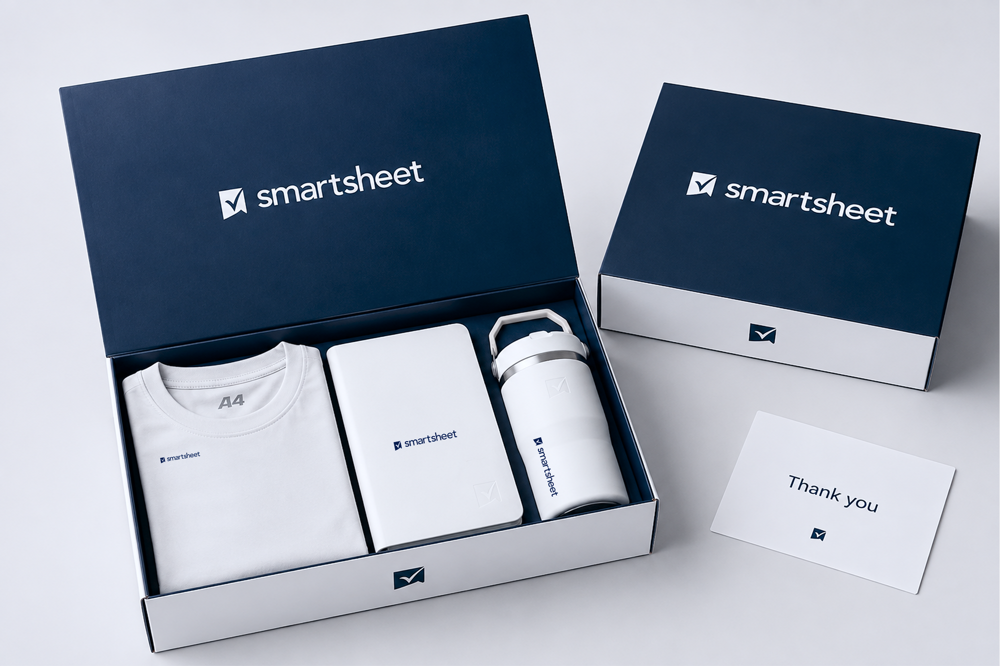 Branded employee gift box containing a company t-shirt, insulated tumbler, and swag items, individually packed with a thank you card, representing a Launch company swag store fulfillment.