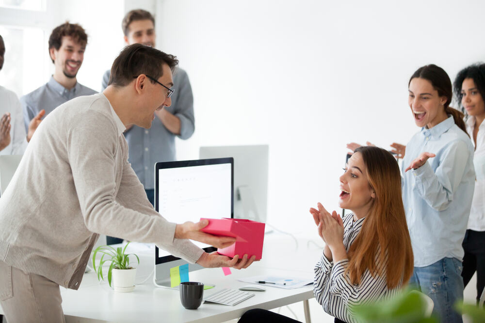 An employer boost morale by presenting a hardworking employee with a gift